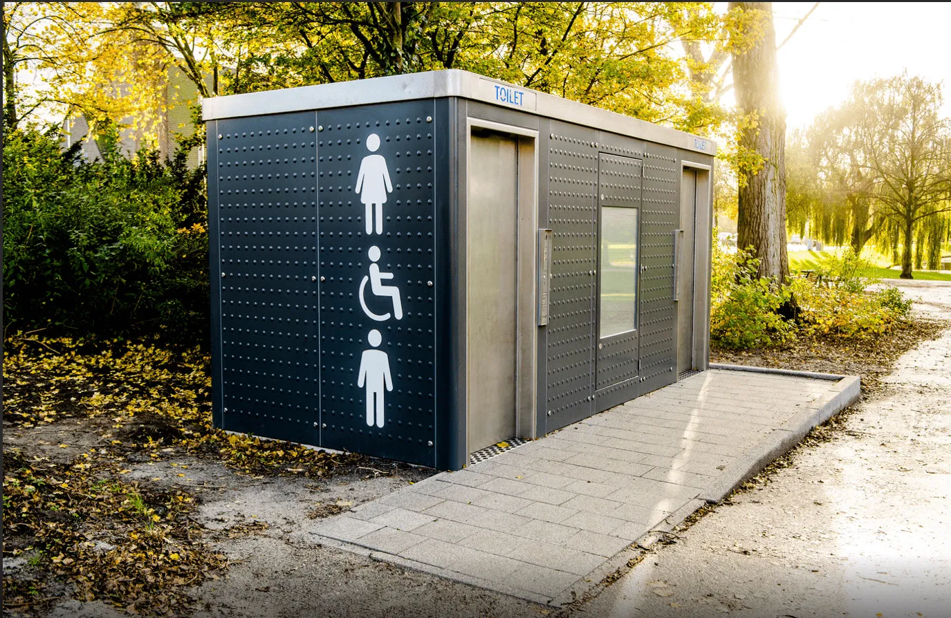 A Sanitronics public toilet unit in a park